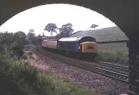 The eastbound <I>Harwich Boat Train</I> rounds the curve at Chinley East Junction behind a Class 45 <I>Peak</I> in the summer of 1978. This was prior to the reinstatement of the East to South junctions chord that now allows stone trains direct access to and from the Sheffield direction. [See image 26978] taken from the same bridge thirty years later. [Ref query 438]<br><br>[Mark Bartlett //1978]
