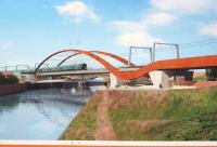 A photograph of a Network Rail billboard outside one of the Ordsall Chord worksites which shows what the bridge over the River Irwell will look like when completed. Compare with the earlier aerial view [see image 15343]<br><br>[John McIntyre 10/01/2017]