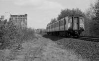 150256 passes the former Dunnikier Foundry siding a little to the west of Sinclairtown with an Edinburgh-bound Fife Circle service. The paved track was worked by a tractor latterly.<br><br>[Bill Roberton //1992]