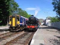 Mallaig-bound Jacobite crosses a ScotRail service at Arisaig on 3rd June 2016.<br><br>[David Spaven 03/06/2016]