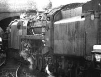 A lengthy car train runs north through Galashiels on 21 May 1964, with an unidentified Black 5 piloting Britannia Pacific 70013 <I>Oliver Cromwell</I>.  <br><br>[Dougie Squance (Courtesy Bruce McCartney) 21/05/1964]