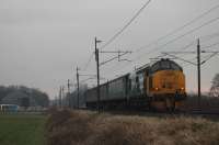 37401 propels the 0515 Carlisle to Preston through Garstang & Catterall on a dull 20th January 2017. The train is about to pass the Highways England salt store that serves the adjacent M6 Motorway.  <br><br>[Mark Bartlett 20/01/2017]