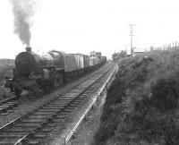Horwich Mogul 42918 with a westbound goods at a wet and lonely Loch Skerrow station on 14 July 1956. The train is on the up line at this point to permit overtaking. [Ref query 678]  <br><br>[G H Robin collection by courtesy of the Mitchell Library, Glasgow 14/07/1956]