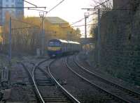 Viewed under the A723 road bridge, a Dalmuir - Larkhall service heads east from Hamilton Central on to the the single track section and into the winter sunshine. <br><br>[Colin McDonald 27/01/2017]