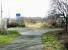 Site of the flat crossing of the lines from Granton and North Leith at Bonnington in March 2003. View is southeast towards Powderhall where the line currently terminates at the refuse disposal depot on Broughton Road, which can be seen in the right background. Off to the left is the former route to North Leith while to the right lies Warriston Junction, Scotland Street and, long ago, Canal Street. <br><br>[John Furnevel 10/03/2003]