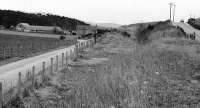 With the A95 road at Gaich on the extreme right, the railway track bed can be seen heading away towards Broomhill in April 1977. [See image 21050] for a view some 30 years later.<br><br>[John McIntyre /04/1977]