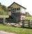 The surviving signal box at Cliburn, Cumbria, in May 2006. Located on the northern section of the Eden Valley line, the station closed to passengers in 1956 with the line itself closing completely 6 years later. View is east over the site of the old level crossing, with the former station building, now a private residence, located off picture to the right [see image 35003].<br><br>[John Furnevel 11/05/2006]