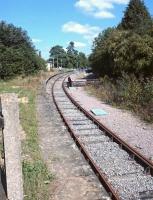Looking along the former Cirencester platform at Kemble railway station on the 30th of August 2016, now an engineer's siding which peters out after a short distance beyond the platform in a station car park.<br><br>[Alan Cormack 30/08/2016]