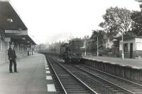 Standard class 4 2-6-4T 80000 photographed at Corkerhill station on 30 June 1959 with a St Enoch - Largs train. 'Corkerhill railway village' and signal box can be seen in the background. [See image 19972] <br><br>[G H Robin collection by courtesy of the Mitchell Library, Glasgow 30/06/1959]