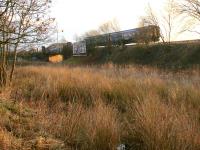 A 2014 winter morning view across what became the carriageway of the new section of the M8 as a class 156 DMU approaches Bargeddie.<br>
<br><br>[Colin McDonald 30/01/2014]