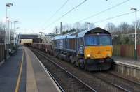 DRS 66430 slows the Carlisle to Crewe infrastructure train through Euxton Balshaw Lane on 9th March 2017, waiting for the Balshaw Lane Junction signal to clear to join the two track section to Wigan. The train mainly comprised loaded stone wagons but track machine DR77904 was also being hauled. <br><br>[Mark Bartlett 09/03/2017]
