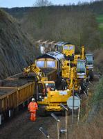 Busy scene to the west of Aberdour as a road-rail machine trims the load of spent ballast.  Freightliner 66544 is in the background.<br><br>[Bill Roberton 19/03/2017]