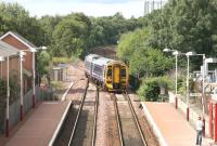 A ScotRail 158 comes off the Anniesland line and crosses over to the up platform  at Maryhill to pick up the waiting passenger on a sunny afternoon in August 2006. The train is 15 minutes from its ultimate destination at Glasgow Queen Street. <br><br>[John Furnevel /08/2006]