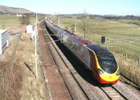 The 1140 Glasgow Central - London Euston Virgin Pendolino glides south through the site of Lamington station on 27 March 2017. Nothing remains of the station itself, which closed to passengers at the end of 1964, although the location is now used as an access point by Network Rail. [See image 6561]<br><br>[John Furnevel 27/03/2017]