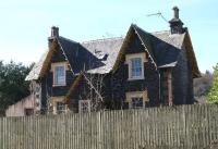 Front view of the fenced off (and slightly creepy looking) former station master's house at Beattock. Photographed looking west in April 2016, with the WCML running past just beyond. [see image 58672].<br><br>[John Furnevel 27/03/2017]