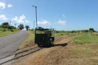 Motor trolley at the La Vallee turning circle of the St Kitts Scenic Railway. The trolley runs ahead of the passenger train with the driver operating some of the level crossing barriers. It is sitting on the points leading to the disused west coast section of the line to Basseterre which continued south from here.<br><br>[Mark Bartlett 18/02/2017]