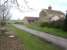 Looking north east to the extended crossing keepers cottage sited on the east side of the former Starfitt Lane level crossing, with the line running across from the piece of dark ground at centre left of view. The line ran along two short lengths of embankment between Kirkdale Viaduct, some 250 metres to the west, and the level crossing, and then entered a shallow cutting, now infilled where is forms the cottage garden, en route east to Kirbymoorside.<br><br>[David Pesterfield 01/03/2017]