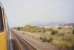 The diverted Birmingham train [see image 58378] has joined the main section of the South Sub at Niddrie West Junction. Another train hauled by a Class 37 loco is held at the signal possibly heading for Millerhill Yard. Arthur's Seat is wreathed in a summer haze in the background.<br><br>[Charlie Niven /07/1989]