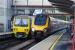 A southbound Arriva XC arrives at Platform 2 as a Northern Class 323 EMU departs for Manchester from Platform 1. Macclesfield is the location and 25 September 2016 is the date.<br><br>[John McIntyre 25/09/2016]