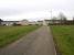 View south east just past the site of Bothwell Junction. The line from Bothwell station ran through red brick building on the right and continued behind the camera towards Uddingston East. The line which forked off to run north east towards Whifflet curved round through the houses on the left. In between was a series of sidings. For a view in the opposite direction [see image 58572].<br><br>[Colin McDonald 29/03/2017]