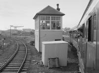 107 444 approaches Rosyth Dockyard signalbox with the 'Tay Forth Venturer' on 16 June 1984. In the left background is the Dockyard station with another DMU present.  The 'box is a NBR type 7, unusually of timber construction. Closed on 7 July 2008 it is listed Category-B.<br><br>[Bill Roberton 16/06/1984]