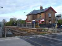 Looking east across the level crossing dividing Bridlington Street, to left, and Bridlington Road to the former Hunmanby Station House sited behind the southbound platform for Bridlington, Beverley and Hull. The track is double from Seamer to just after the level crossing, and then single going forward to Bridlington.  <br><br>[David Pesterfield 17/04/2017]