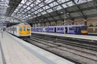 Two <I>Northern Electrics</I> sit in the north side platforms at Lime Street station on 6th April 2017. 319450, newly arrived from Preston, is as yet unbranded but 319382, waiting on the right to depart to Warrington, has full Northern livery. <br><br>[Mark Bartlett 06/04/2017]