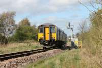 150223 trundles along the single track chord between Bare Lane and Hest Bank with the 1605 Lancaster to Leeds (via Morecambe) service on 12th April 2017. This is one of only two passenger trains to traverse this link on weekdays. The catenary masts of the WCML can just be seen behind the signal. <br><br>[Mark Bartlett 12/04/2017]