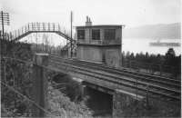 This is a  BR PR&PO photograph originally taken by the LNER in 1945 showing Faslane Junction signal box.<br><br>
<br><br>
This was the junction for the yard and short branch to the Military Port. The West Highland was doubled at the junction.<br><br>
<br><br>
From the rear side of this photograph we have the details of the year and that the negative is held by the LNER Engineers Department, Edinburgh. A stamp reads The Railway Executive, Scottish Region, Public Relations and Publicity Office, 179 Howard Street, Glasgow, G.1. Hand written is the reference SB5Y85.<br><br>[PR&PO British Railways (Douglas Blades Collection) //1945]