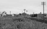 Looking west towards Forres Station and signalbox in 1991.  On the right is the course of the original route and site of station, soon to be the location of a new facility.<br><br>[Bill Roberton //1991]