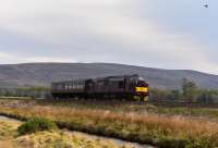 Following <i>The Great Britain X</i> West Coast Railways Class 37, No.37685 <i>Loch Arkaig</i> and a support coach cross the moor at Moy on the final leg of the journey to Inverness, escorted by a duck.<br><br>[John Gray 01/05/2017]