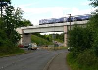 The ScotRail 0924 Edinburgh - Tweedbank crossing Hardengreen Viaduct on 18 May 2017, seen looking south west towards the roundabout along the B6392.<br><br>[John Furnevel 18/05/2017]