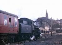 Looking south east towards Alston station on 26 March 1967, with Ivatt 2-6-0 no 43121 at the head of the recently arrived BLS/SLS <i>Scottish Rambler no 6</i>. [See image 35215]<br><br>[Bruce McCartney 26/03/1967]