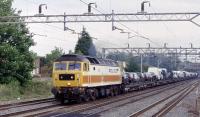 Class 47 in 'Police' livery on a northbound car-train at Headstone Lane. As I took this picture, with the train approaching, the 47 was making such a racket I thought it was going to collapse into pieces !<br><br>[Bernard Holland 04/07/2003]