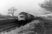 37140 and a rake of tank wagons climb eastwards on Hoghton bank on 1st December 1978. The tanks will probably be empties from Preston Dock or Burn Naze returning to Immingham. 37140 had a further twenty years main line service but was stored in June 1999 and cut up two years later at Springs Branch.  <br><br>[Mark Bartlett 01/12/1978]