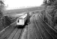 A Class 108 Derby DMU heads west between Chester and Saltney Junction on 22nd June 1980. The train has just crossed the Shropshire Union Canal and is now passing under the first of two bridges that carry a section of the city walls over the railway, this view taken from the second bridge.. <br><br>[Mark Bartlett 22/06/1980]