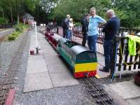 <I>Battery or Steam power?</I> Discussion on the relevant motive power merits at the Cinderbarrow Miniature Railway during a private evening visit in June 2017. The resident Bo-Bo BE, loosely resembling a Class 58, has 3x8v batteries and a 1hp motor on each axle so has real pulling power. View across the station site towards the signal box.<br><br>[Mark Bartlett 14/06/2017]