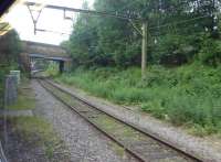 Grab shot from a Hadfield train of the <I>main line</I> platform at Dinting on 16th June 2017. This platform is still used by a few rush hour trains but the majority avoid this chord to access the Glossop branch on the other two sides of the triangle. Dinting signal box, which controls trains in the Glossop and Hadfield area, can just be seen beyond the bridge [See image 42379]. <br><br>[Mark Bartlett 16/06/2017]