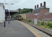 A Blackpool to York service waits in Platform 1 at Blackburn while a Clitheroe service clears the short section to Daisyfield Junction. The original station building can be seen on the right contrasting with the newer platform buildings. [See image 51349] for an exterior view. .<br><br>[Mark Bartlett 16/06/2017]