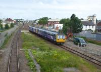 A four car Pacer train slows for the Kirkham stop with a Blackpool North to Hazel Grove service on 16th June 2017. Alongside the surviving running lines work is taking place on the site of the recently lifted fast lines in connection with electrification and Kirkham's new third platform. <br><br>[Mark Bartlett 23/06/2017]