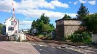 A view of the level crossing, signal box and former water tank (with totem) at Insch from the 'Inverness' end of the station. This is perhaps the best example of a close to intact smaller GNoSR station.<br><br>[Alan Cormack 23/06/2017]
