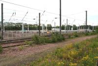 Construction of stabling roads and erection of catenary associated with the new Millerhill electric train depot well advanced on 9 July 2017. View south east over the freight-only lines, with the Borders Railway behind the camera. <br><br>[John Furnevel 09/07/2017]