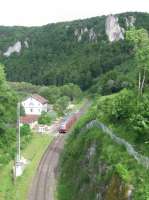 An IRE service pauses at the monastery village of Beuron in the Danube gorge on 6th June 2017. The station loop is long gone and the station building is now used as a Haus der Natur for visitors, staffed by the regional park authority.<br><br>[David Spaven 06/06/2017]