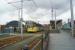 A Metrolink tram calls at Deansgate-Castlefield whilst working to Manchester Airport on 19 May 2017. Deansgate railway station is to the right and the roof of the former Manchester Central station is in the left background.<br><br>[John McIntyre 19/05/2017]