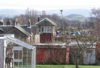 Looking east along the trackbed at Biggar in February 2004 with housing developments and a scrapyard gradually encroaching on the site of the old station.<br><br>[John Furnevel 09/02/2004]