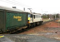 An up Freightliner container service speeds through Carstairs in December 2004.<br><br>[John Furnevel 02/12/2004]