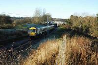On the first day of public service a train passes Merryton Junction joining the former Mid Lanark lines route to Larkhall Central.<br><br>[Ewan Crawford 12/12/2005]