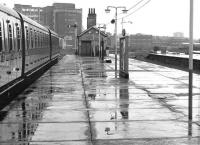 A North London Line service to Richmond about to depart from a rainsoaked Broad Street in August 1984. An inbound train is approaching centre right.<br><br>[John Furnevel 11/08/1984]