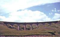 The gracefully curved Rispin Cleugh Viaduct near Leadhills on the Wanlockhead branch, built in 1891 by Sir Robert McAlpine & Co. The eight arch viaduct was of concrete construction clad with terracotta bricks to improve its appearance. It was demolished using explosives in December 1991. Some of the terracotta bricks were later used to clad the signal box at Leadhills station. [See image 11099]     <br><br>[John Robin //]