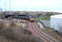 A coal train for Cockenzie leaves Leith Docks via South Leith yard and emerges from the bridge under Seafield Road in February 2006.<br><br>[John Furnevel /02/2006]